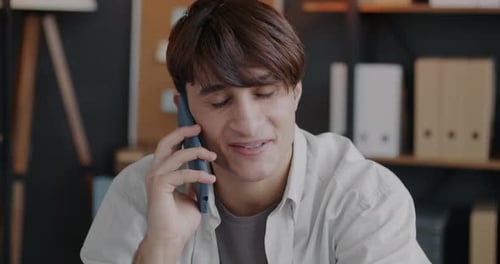 Middle Eastern Man Making Mobile Phone Call Speaking Discussing Business Indoors in Office
