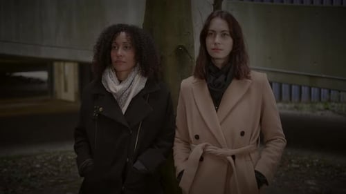 Lifestyle Portrait of Two Young Women Watching Tower Building Together