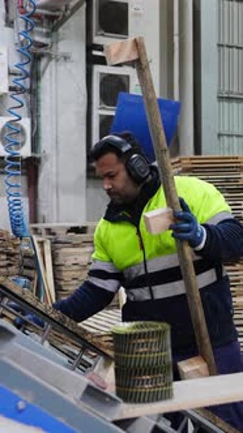 Adult Working with Wood in Factory Setting