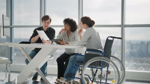 Young Business Woman Sitting Wheelchair While Work Young Business People Working in Office Workplace