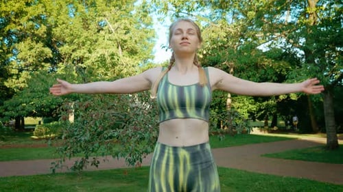Blonde Woman Practicing Yoga in the Park