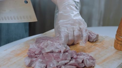 Chef Chopping Meat With Cleaver