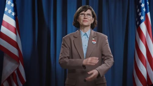 Woman Standing with American Flags and Vote Pin