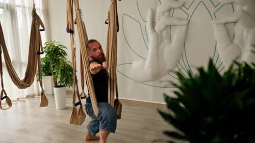 Bearded Man Doing Aerial Yoga at Studio