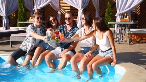 Friends Toasting Drinks at Swimming Pool