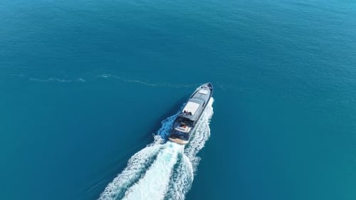 Yacht Cruising on Deep Blue Ocean Aerial View