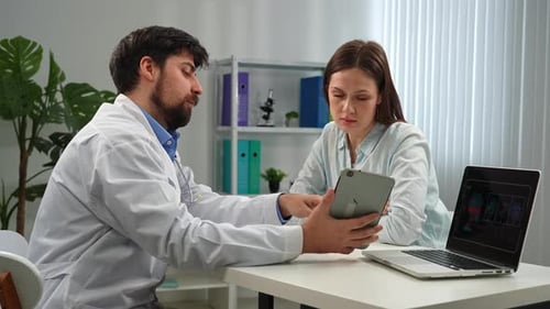 Doctor and Patient Discussing Medical Diagnosis in Office