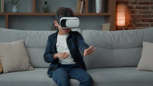 Boy Enjoys Virtual Reality on Gray Couch