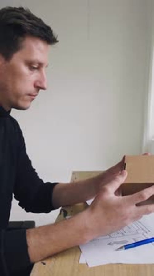 Designer Works Develops the Design of the Box In the Office of a Design Studio a Designer Comes Up