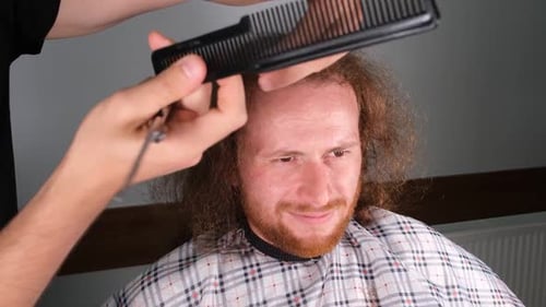 Man Getting a Haircut with Comb and Scissors