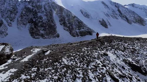 Hiker on Snowy Mountain Ridge in Winter