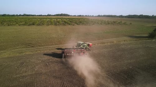 Tractor on the field seeding wheat