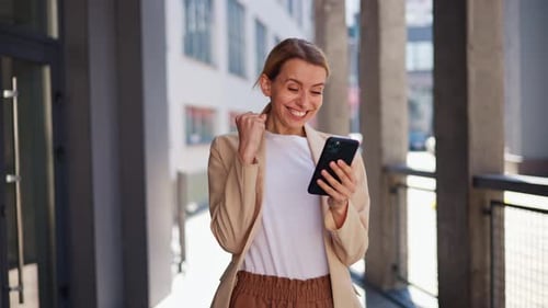 Excited Woman Celebrates Good News on Phone
