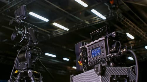 Professional high-end cinema camera with sensor block separated and mounted on a tripod and fluid he