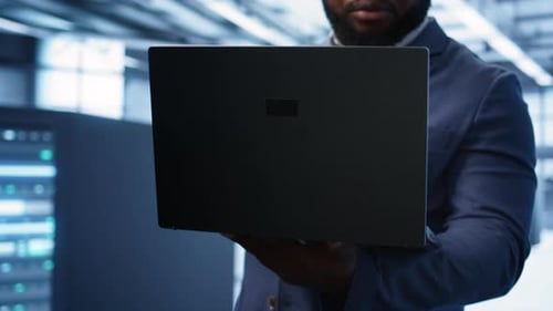 Close Up of IT Professional in Data Center Fixing Errors