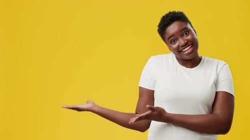 Smiling Young African American Woman Showing Excitement in a Vibrant Studio