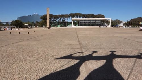 silhouette of the sculpture Dois Candangos and building of Supreme Federal Court on background. Bras