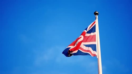 British Flag Waving against a Clear Blue Sky