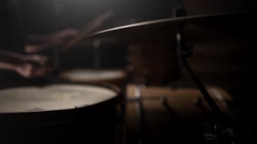 Drummer Playing Drums Kit in Dark Studio