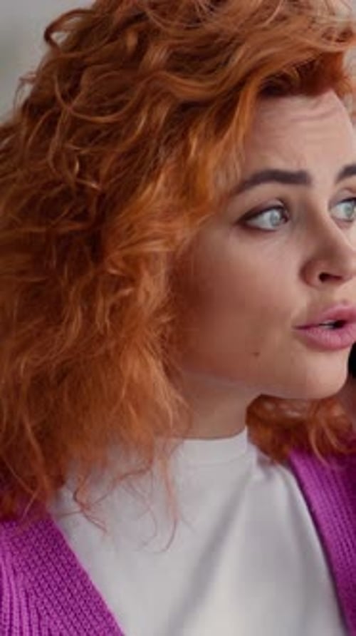 Woman With Curly Red Hair Talking on Phone