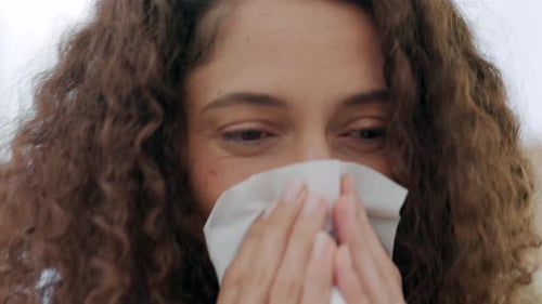 Woman with Cold Using Tissue Close Up