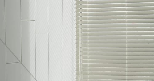 Modern Window Blinds Casting Soft Shadows on White Wall