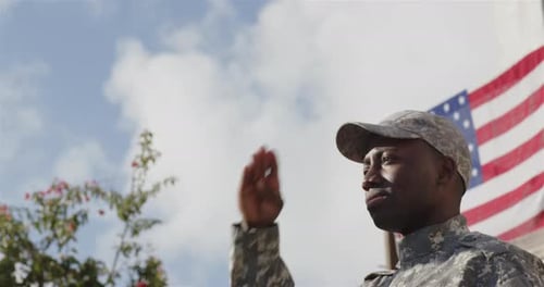 Young adult salutes the American flag