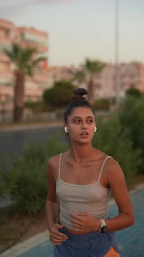 Young Woman Jogging on Path in Urban Setting