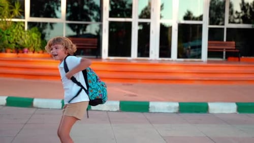 School Student Child with Backpacks Playing Spinning in Yard During Study Break Back to School