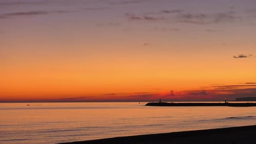 Time lapse dawn seascape, boats leaving harbor at sunrise