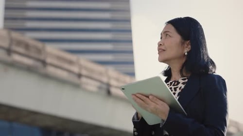 Mature Lady Thinking Holding Tablet Texted on Ideas for Business Strategy