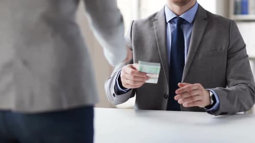 Businessman accepts money bribe from woman for corruption in office concept