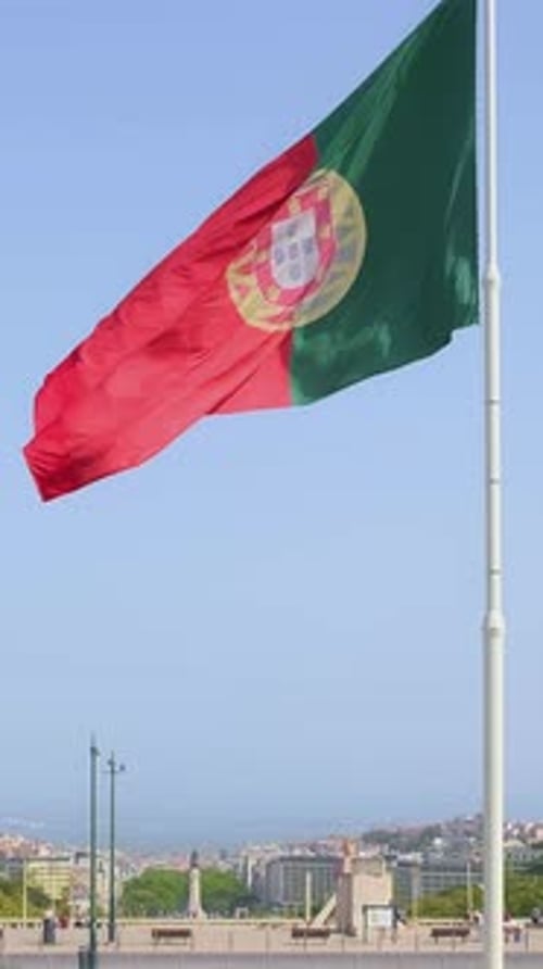 National Flag of Portugal Waving in the Wind on Clear Sunny Day at Blue Sky in Park of Edward VII