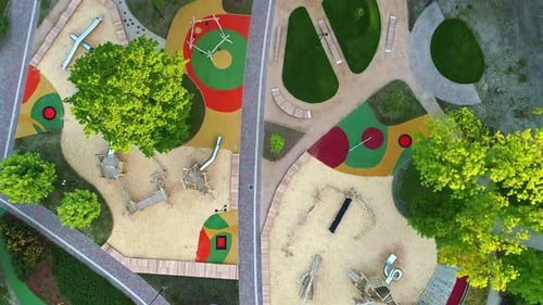 Aerial top down shot above a modern, newly landscaped park and playground