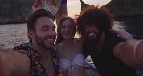 Multi ethnic friends capture Thailand boat tour memories with smartphone