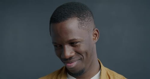 Man Giving Wry Smile in Close Up Portrait