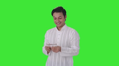 Happy Indian man counting money Green screen