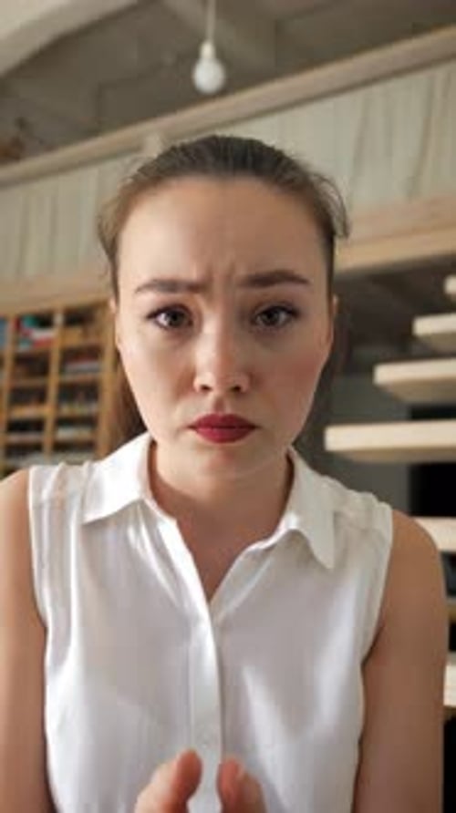 Vertical of Woman Offers Excuses Talking on Video Call with Friend