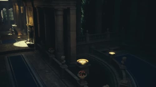 Quiet Ceremonial Corridor Cast in Warm Glow From Oil Lights and Carved Columns