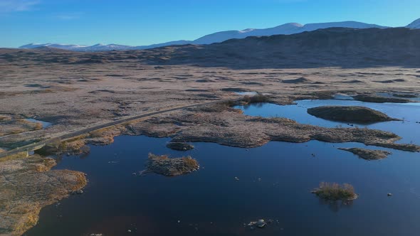 Aerial establishing shot of the moorlands in winter at the Rannoch Moor ...