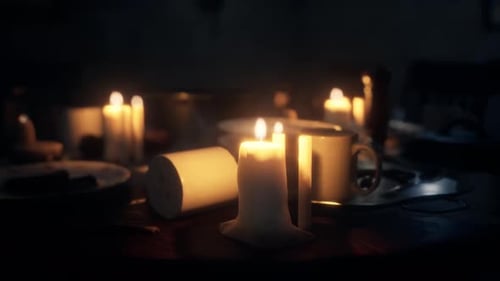 Warm Candlelight Flickering on Dark Table