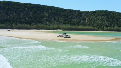 Aerial 4K Drone Over Cars With Camping Setup On Sandy Beach Shore Beside Ocean, Australia