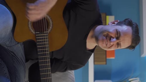 Man Plays Acoustic Guitar Indoors