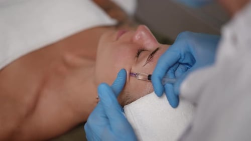 Woman receiving facial injection treatment at medical spa