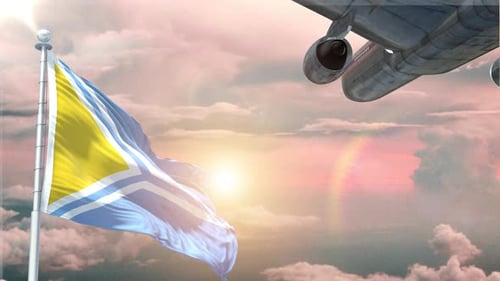 National Flag Waving With Passenger Airplane Flying At Sunset