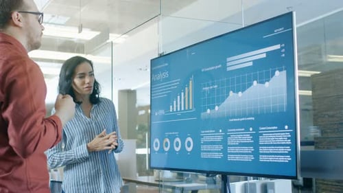 Business Colleagues Discuss Analysis Data on Screen