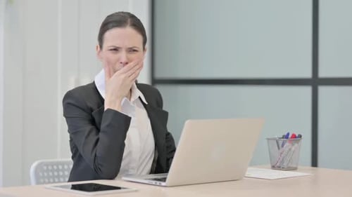 Business Woman Coughing at her Desk