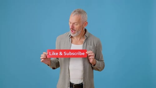 Joyful Man Shows Button with Phrase Like and Subscribe