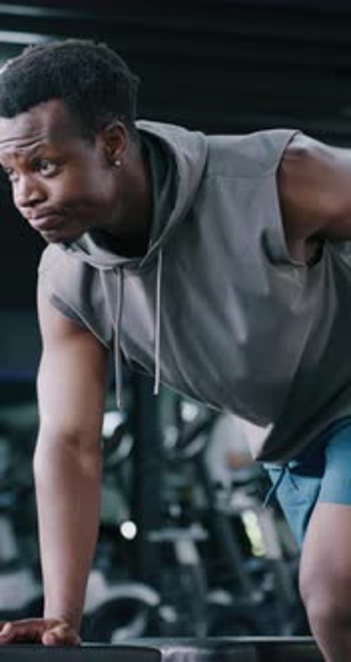 Fitness, dumbbells and man in gym with workout, bodybuilding or training for strength