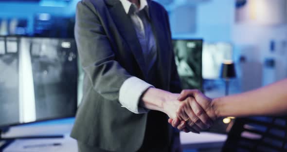 Handshake, security and control room for surveillance at office for ...